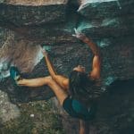 photo of woman climbing mountain