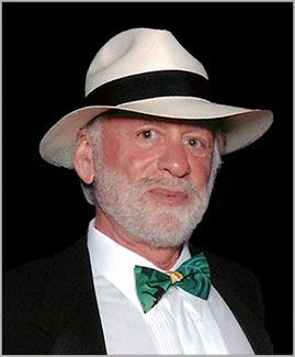 Professional portrait of Leonard Frieling in a tropical tuxedo and a Panama Hat. They're all made in the Ecuador.