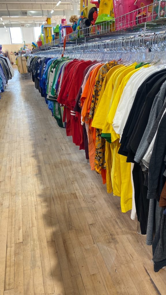 a row of shirts hanging on a rack in a store
