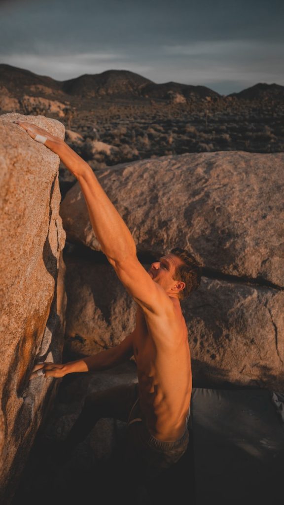 man climbing rock
