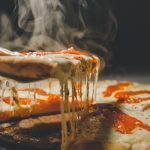 close up photo of pizza with cheese