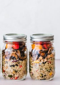 three full clear glass jars with lids