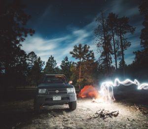 white car near bonfire during night time
